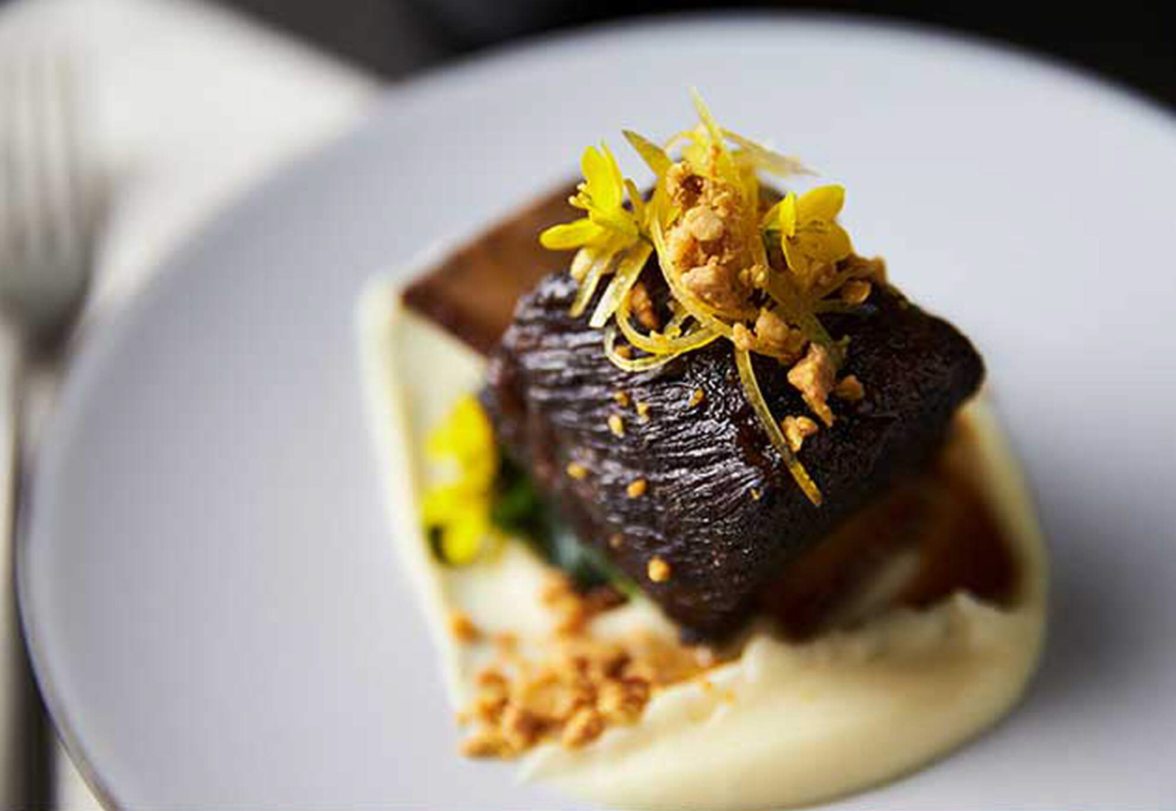 Short Rib Pastrami with Parsnip Puree, Wilted Arugula and Curried Almond.