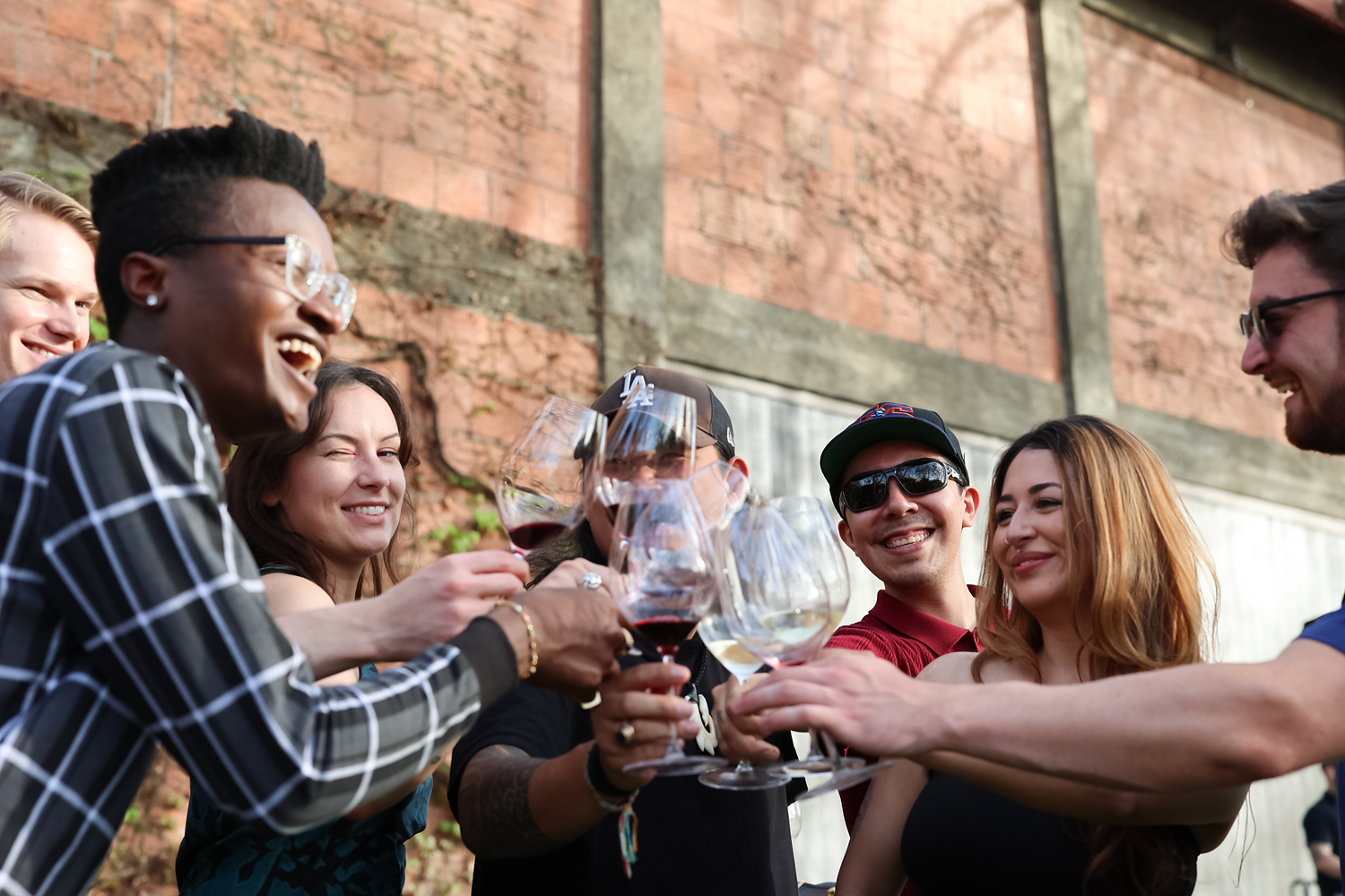Louis M. Martini Event - group of people cheers with wine glasses
