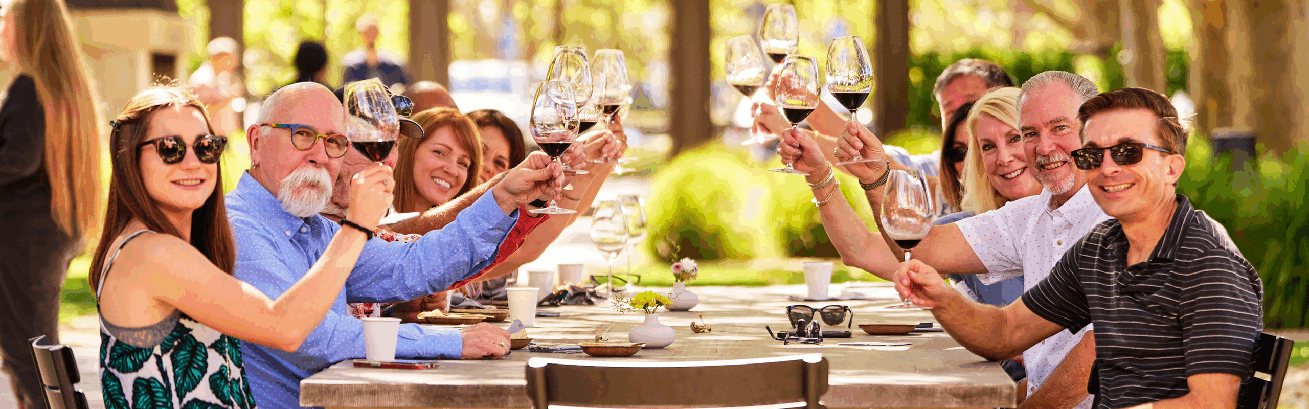 Louis M. Martini Events - group of people cheersing at a table with wine glasses
