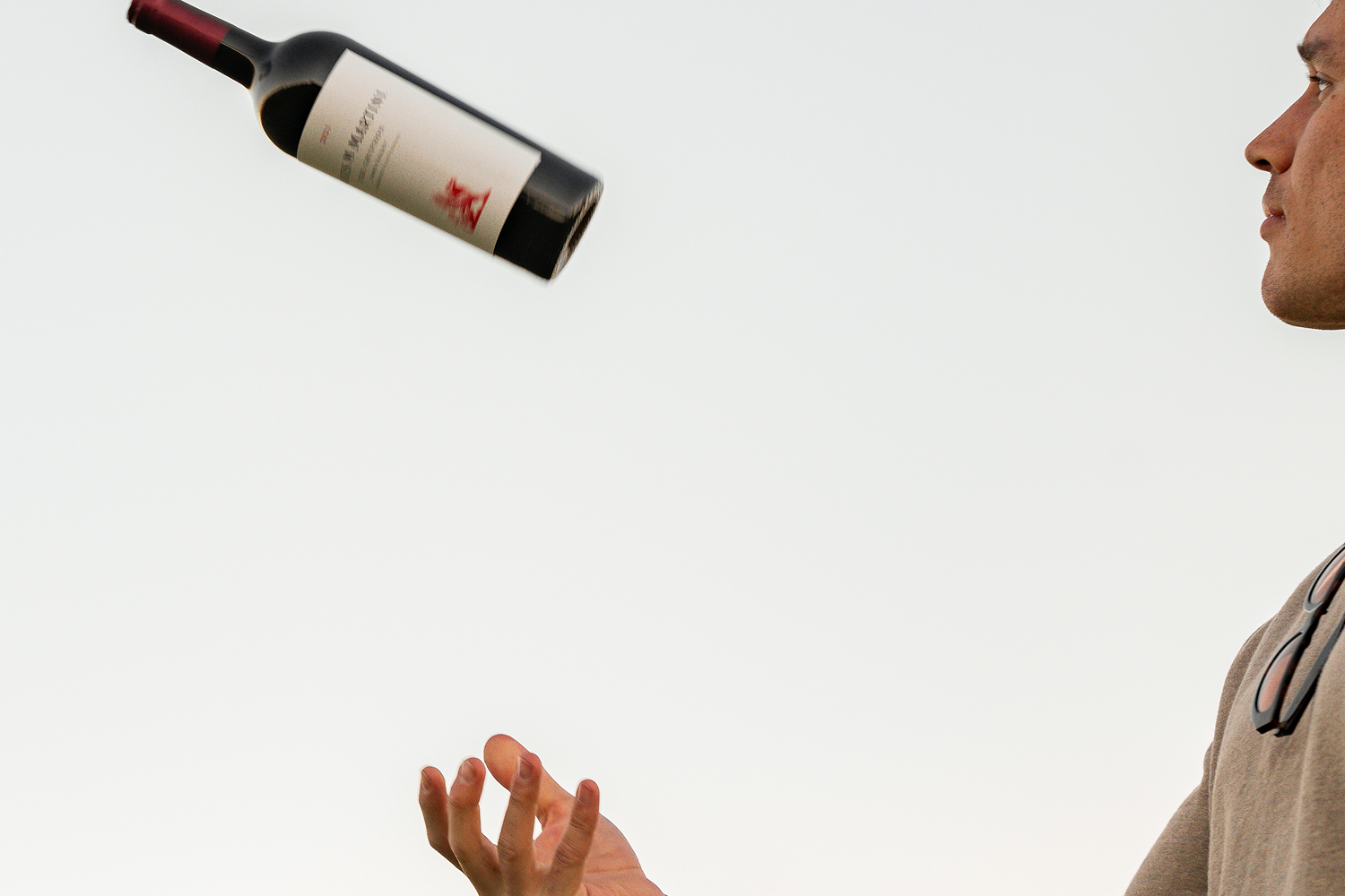 person throwing Louis M. Martini The Gryphon bottle in the air