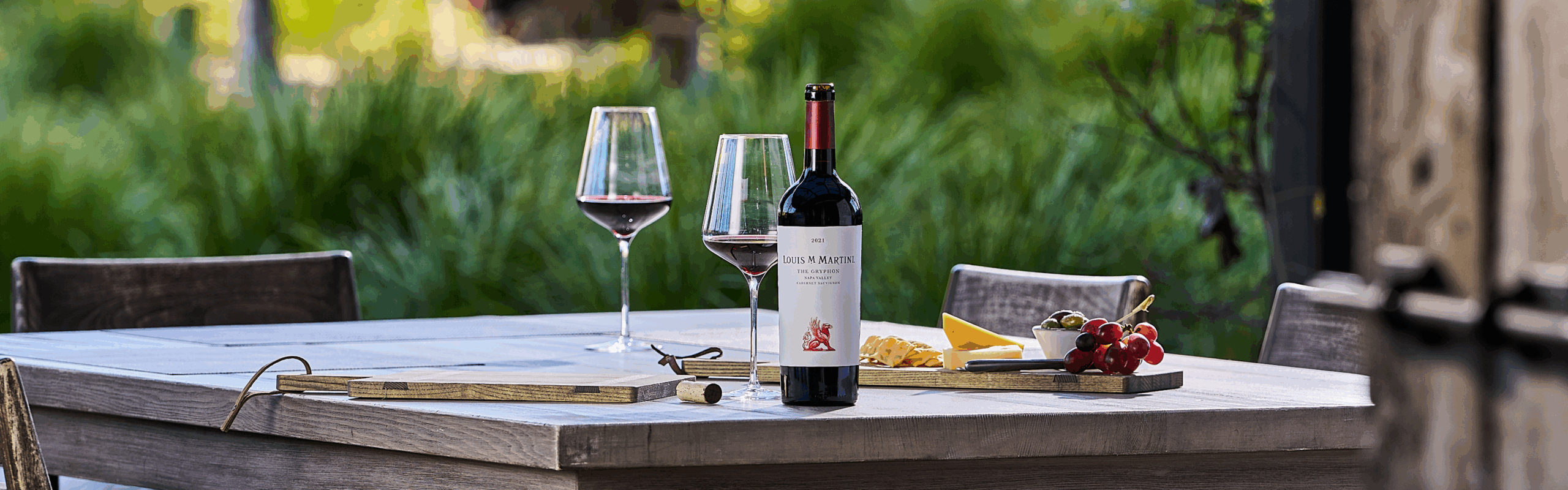 Louis M. Martini The Gryphon Cabernet Sauvignon on table outside with cheeseboard