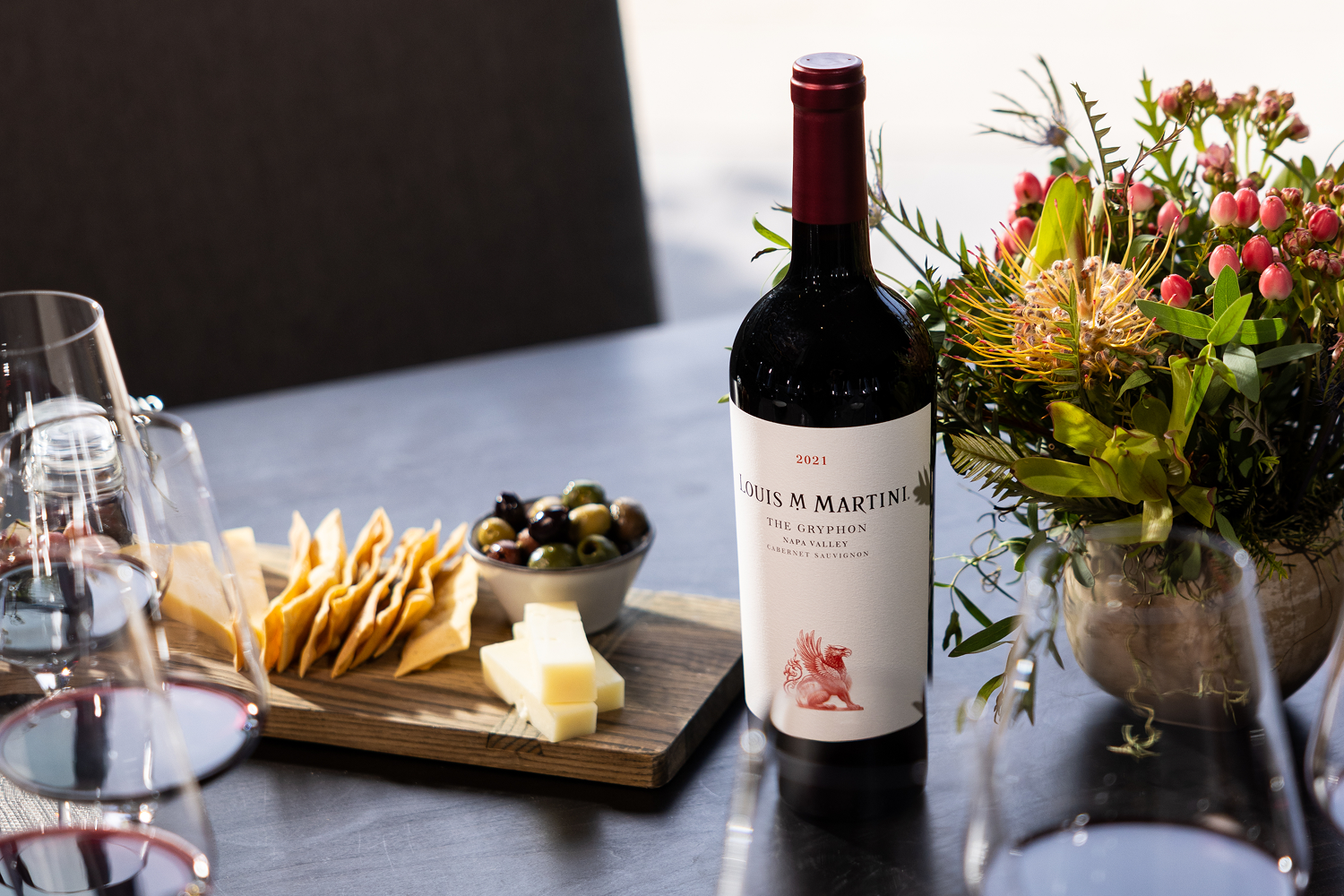 The Gryphon Napa Valley Cabernet Sauvignon on table with cheeseboard