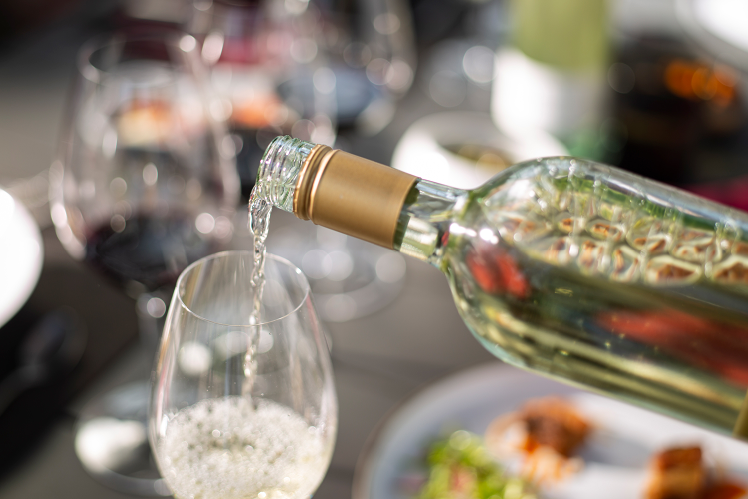 Sauvignon blanc being poured into wine glass