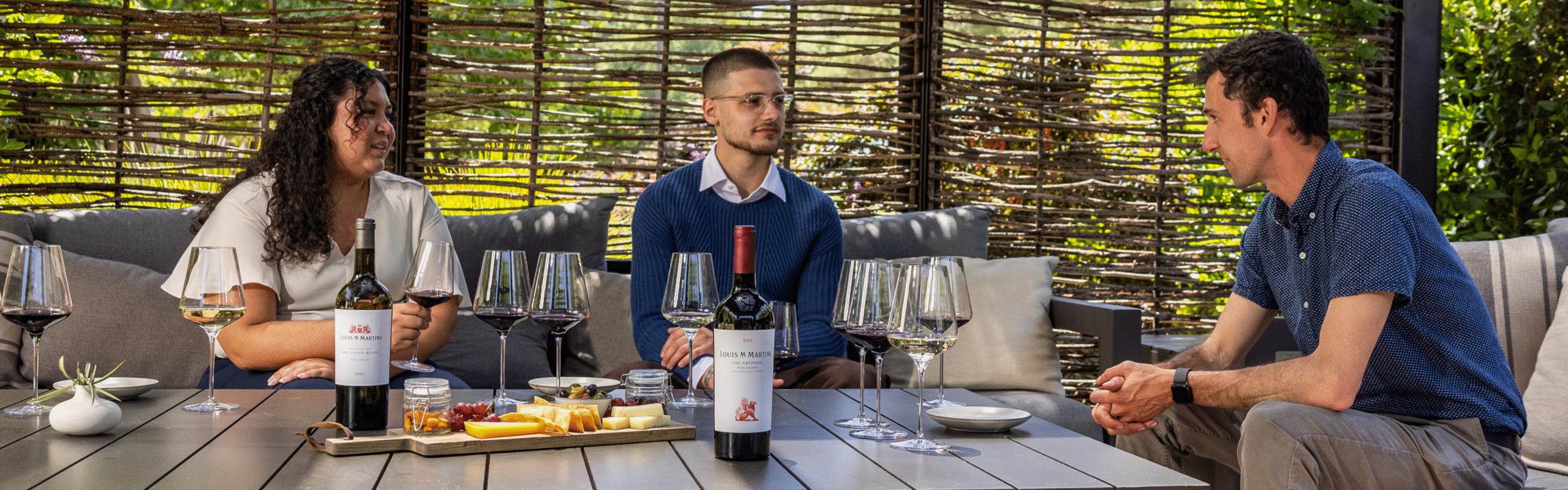 people sitting in cabana enjoying wine and food