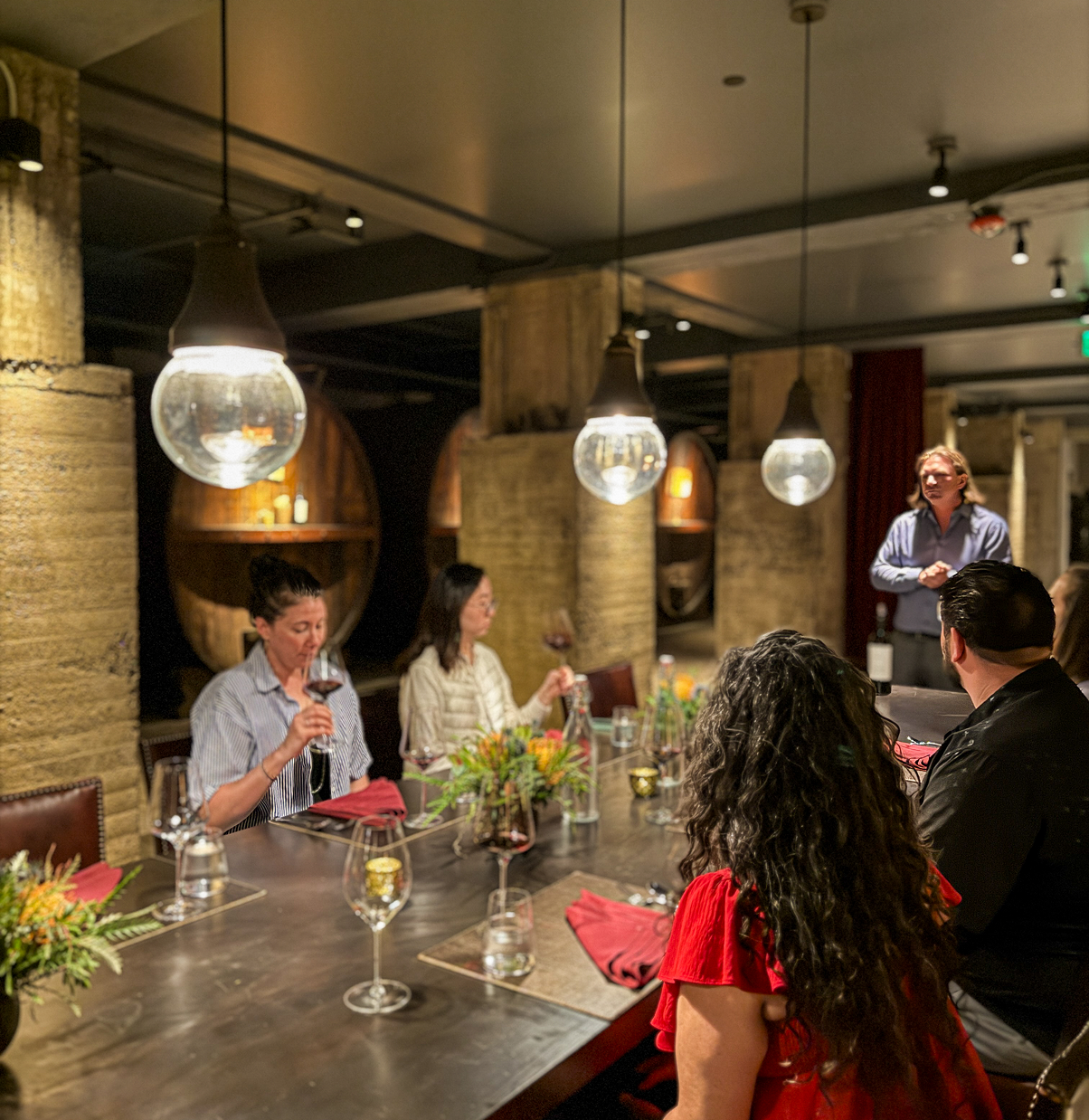 people sitting at table in underground cellar at louis martini winery