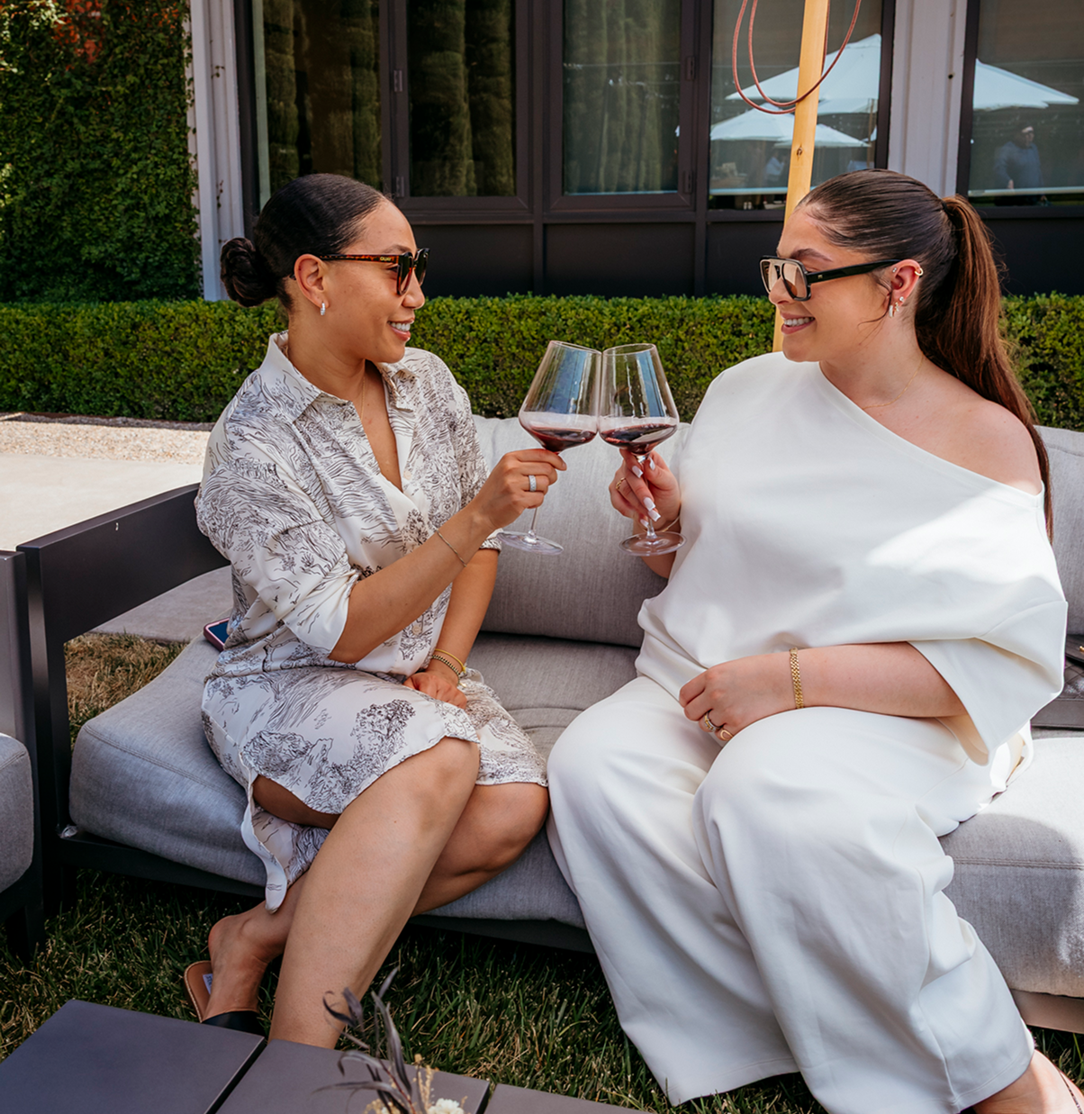 two people cheersing with wine glasses